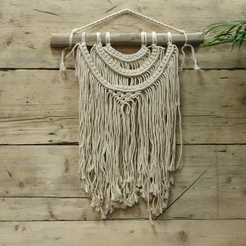 Macrame wall hanging on a wooden wall