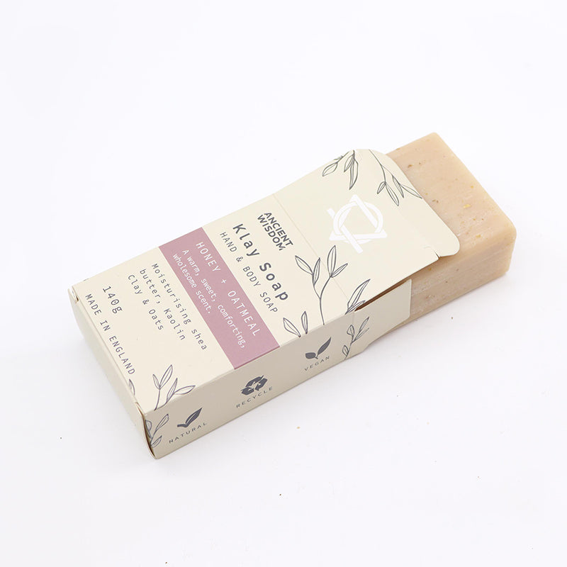 Bar of soap with a Kira Soap packaging on a white background